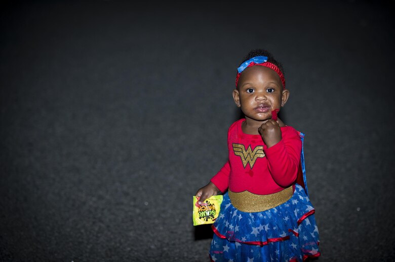 Kinsley Young, daughter of Staff Sgt. Ceaira Young, 23d Wing, eats candy at the Trunk or Treat event Oct. 20, 2017, at Moody Air Force Base, Ga. More than 3,500 Airmen and their families participated in the annual Trunk or Treat event hosted by the 23d Force Support Squadron Youth Programs. (U.S. Air Force photo by Andrea Jenkins)
