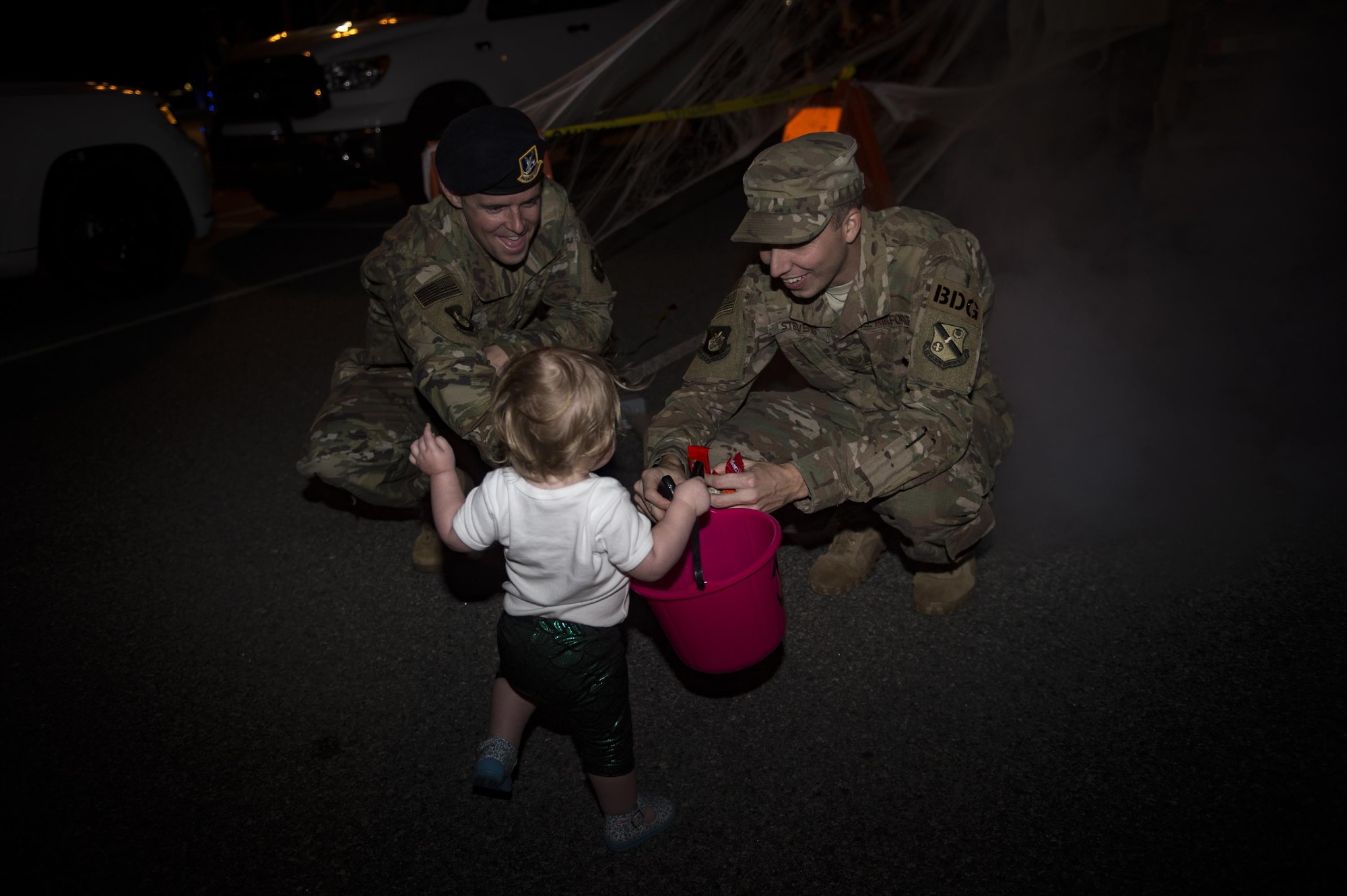 Etta Jenkins, daughter of Senior Master Sgt. Kevin Jenkins, 23d Maintenance Group, collects candy from Airmen at the Trunk or Treat event Oct. 20, 2017, at Moody Air Force Base, Ga. More than 3,500 Airmen and their families participated in the annual Trunk or Treat event hosted by the 23d Force Support Squadron Youth Programs. (U.S. Air Force photo by Andrea Jenkins)