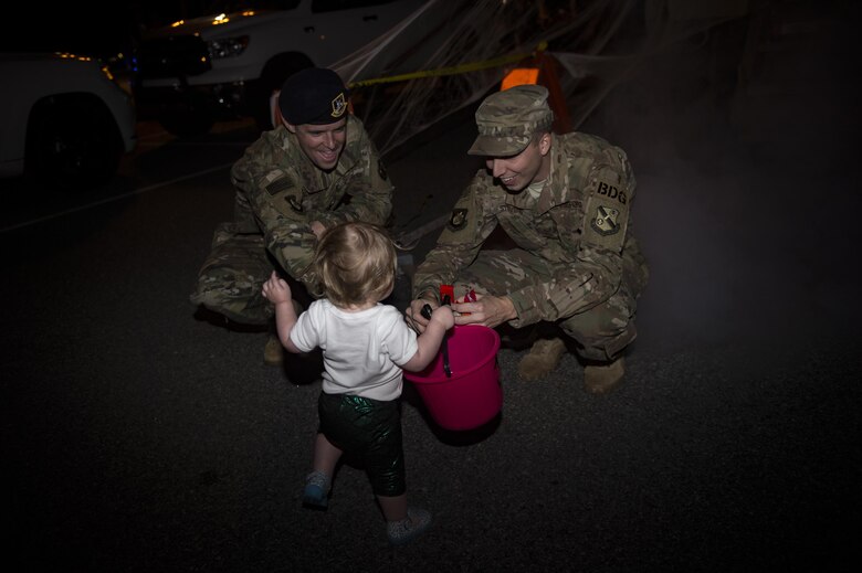 Etta Jenkins, daughter of Senior Master Sgt. Kevin Jenkins, 23d Maintenance Group, collects candy from Airmen at the Trunk or Treat event Oct. 20, 2017, at Moody Air Force Base, Ga. More than 3,500 Airmen and their families participated in the annual Trunk or Treat event hosted by the 23d Force Support Squadron Youth Programs. (U.S. Air Force photo by Andrea Jenkins)