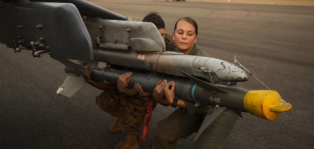 U.S. Marine Corps Cpl. Sydney Adkisson (right) Lance Cpl. Gregory Bolomey (center), and Cpl. Miguel Caraballo (left), aircraft ordnance technicians assigned to Marine Attack Squadron (VMA) 214, unload an AIM-9 CATM missile from an AV-8B Harrier II at the Coeur d’Alene Airport - Pappy Boynton Field, Idaho, Aug. 12, 2017. VMA-214 flew to Coeur d'Alene to celebrate the 10th Anniversary of renaming the airport to "Coeur d'Alene Airport- Pappy Boyington Field."  (U.S. Marine Corps Photo taken by Lance Cpl. Hanna L. Powell)