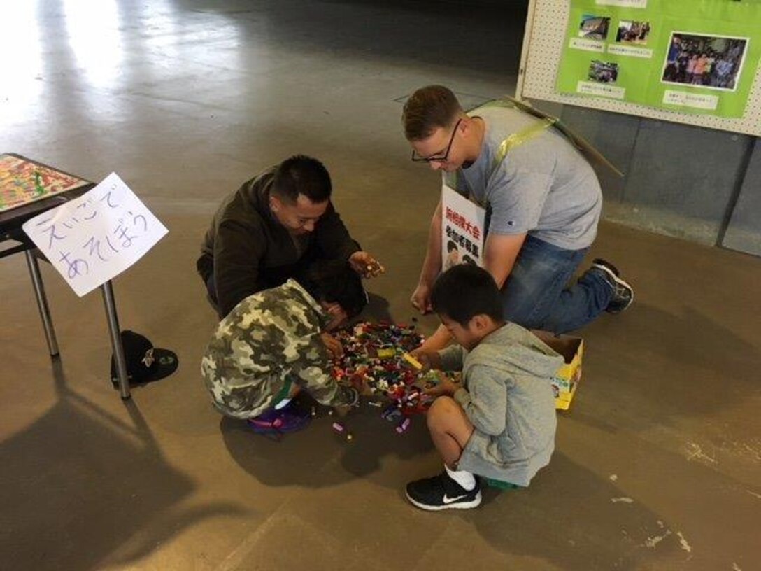 "On Friday 13 October and Saturday 14 October, our Marines helped as volunteers for the Open House festival organized by the National Chuo Youth Friendship Center, just across the road from us.  Our first ever joint summer English Camp back in late August was a great success, and this Open House has also followed suit to be another community relations program which enhanced our mutually supportive relationship between Camp Fuji Marines and our local communities.  Our Marines volunteered to help the Youth Center set up for the event on Friday, the day before the Open House weekend,  by transporting wooden tables down from the camp site to the main stage area.  Special thanks to all CATC, 18, 171 Marines who volunteered over the two days".