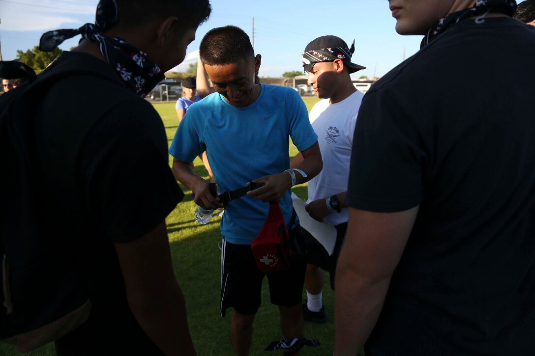 U.S. Marines with Marine Aircraft Group (MAG) 13 receive their first aid kits before the start of the Scavenger Challenge at Marine Corps Air Station Yuma, Ariz., Aug. 12, 2017. The Scavenger Challenge was hosted by Marine Corps Community Services (MCCS) and featured 10 events, where Marines, Sailors, and civilians competed for the chance to take home first place. (U.S. Marine Corps photo by Lance Cpl. Joel Soriano)