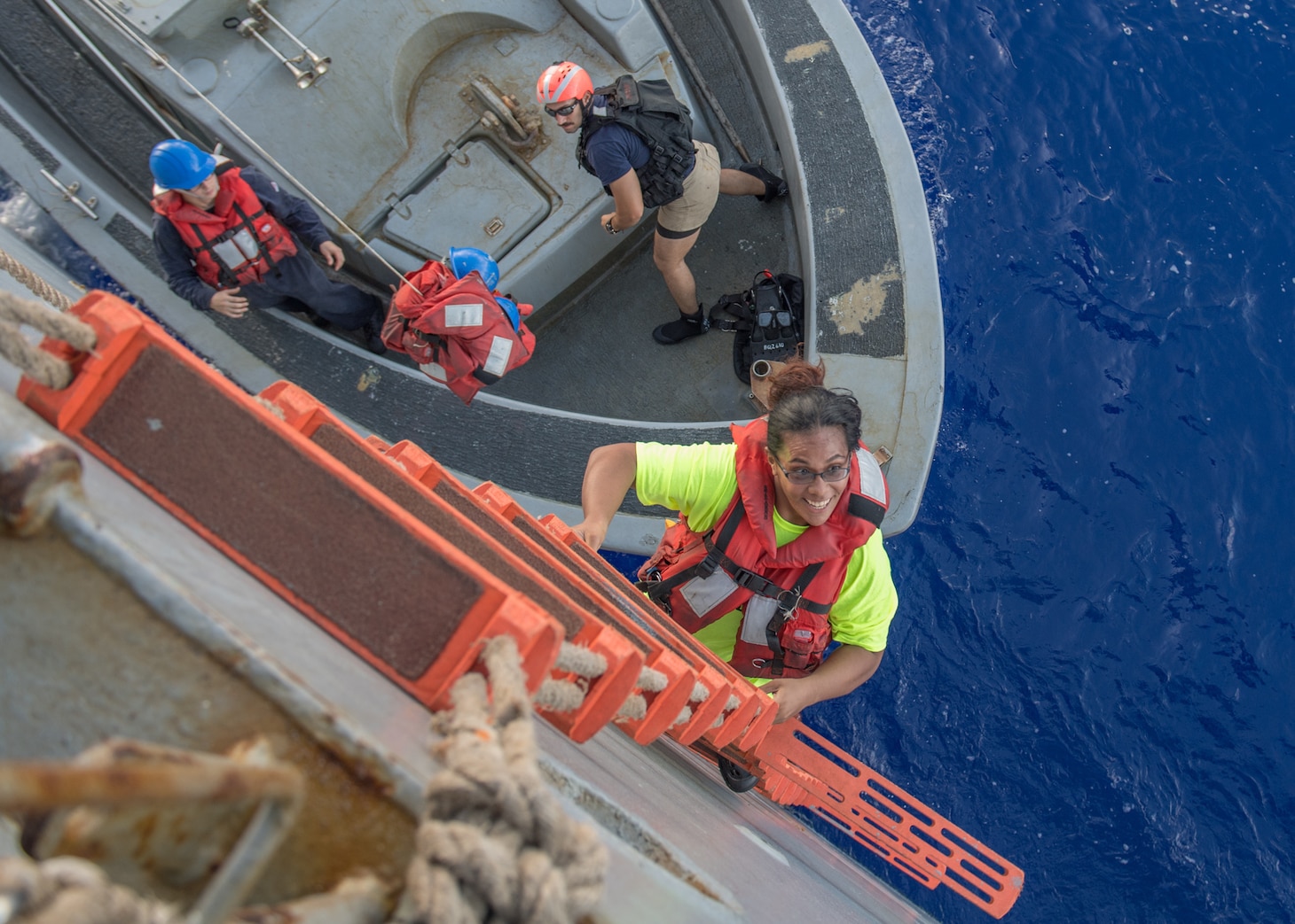 PACIFIC OCEAN (Oct. 25, 2017) Tasha Fuiaba, an American mariner who had been sailing for five months on a damaged sailboat, climbs the accommodation ladder to board the amphibious dock landing ship USS Ashland (LSD 48). Ashland, operating in the Indo-Asia-Pacific region on a routine deployment, rescued two American mariners who had been in distress for several months after their sailboat had a motor failure and had strayed well off its original course while traversing the Pacific Ocean.