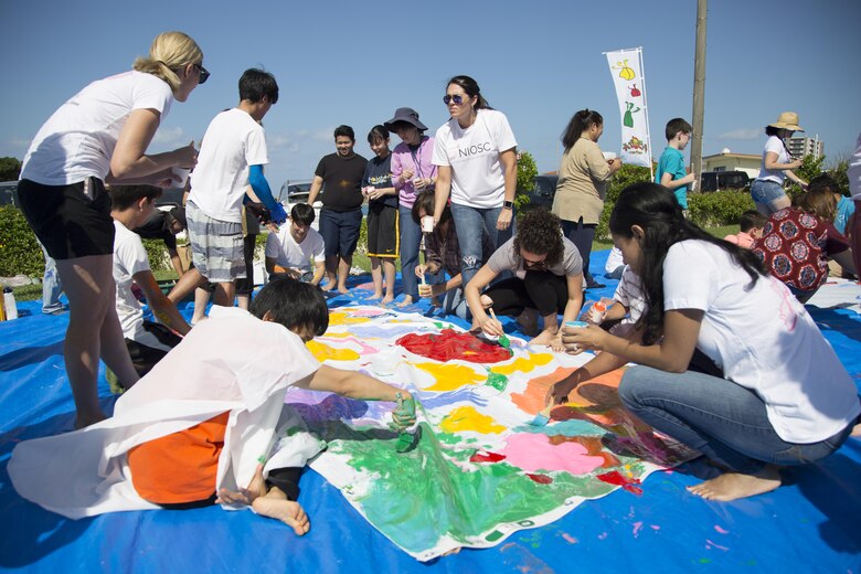 KADENA AIR STATION, OKINAWA, Japan – Members of the local and military communities come together to paint a banner at a community paint project Oct. 26 at the Kadena Marina on Okinawa, Japan.