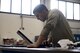 U.S. Air Force Airman 1st Class Jonathan Santiago, 86th Maintenance Squadron Aerospace Ground Equipment journeyman, looks up instructions for servicing a piece of equipment at the AGE facility on Ramstein Air Base, Germany, Oct. 25, 2017. Aerospace Ground Equipment technicians work with many units varying from base to base depending on the mission. (U.S. Air Force photo by Senior Airman Devin Boyer)