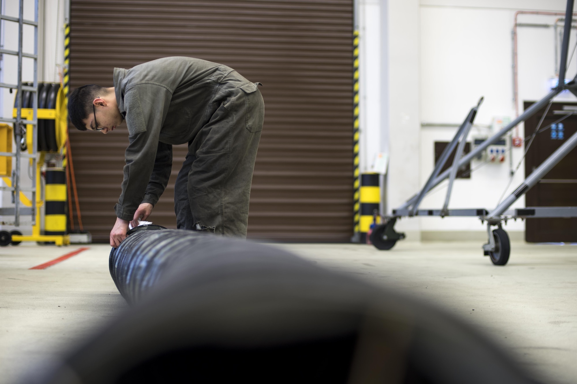 U.S. Air Force Airman 1st Class John Cantu, 86th Maintenance Squadron Aerospace Ground Equipment apprentice, cleans an air duct at the AGE facility on Ramstein Air Base, Germany, Oct. 25, 2017. Part of the inspections process, AGE technicians are required to clean the equipment to ensure they work properly and last longer. (U.S. Air Force photo by Senior Airman Devin Boyer)