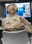 Lt. Col. Jennifer Stowe, an optometrist located at the Brooke Army Medical Center Virtual Medical Center, talks with Sgt. Andrea Bloom Oct. 20 during a synchronous virtual health encounter. The mobile medics connected with Stowe and provided high-definition, synchronous images of a Soldier’s eye using an optical exam camera and web-based video teleconferencing capability.