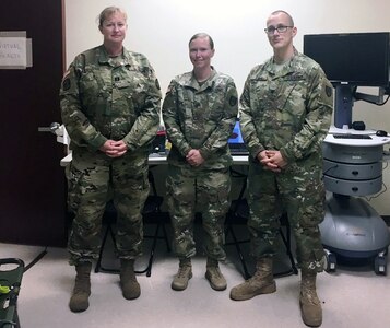 (From left) Capt. Becky Lux, Sgt. Andrea Bloom and Spc. Christian Bark pose for a photo Oct. 26 in Humacao, Puerto Rico. Bloom and Bark are mobile medics from Brooke Army Medical Center who were embedded with the 14th Combat Support Hospital to provide virtual health support to the disaster response effort there.