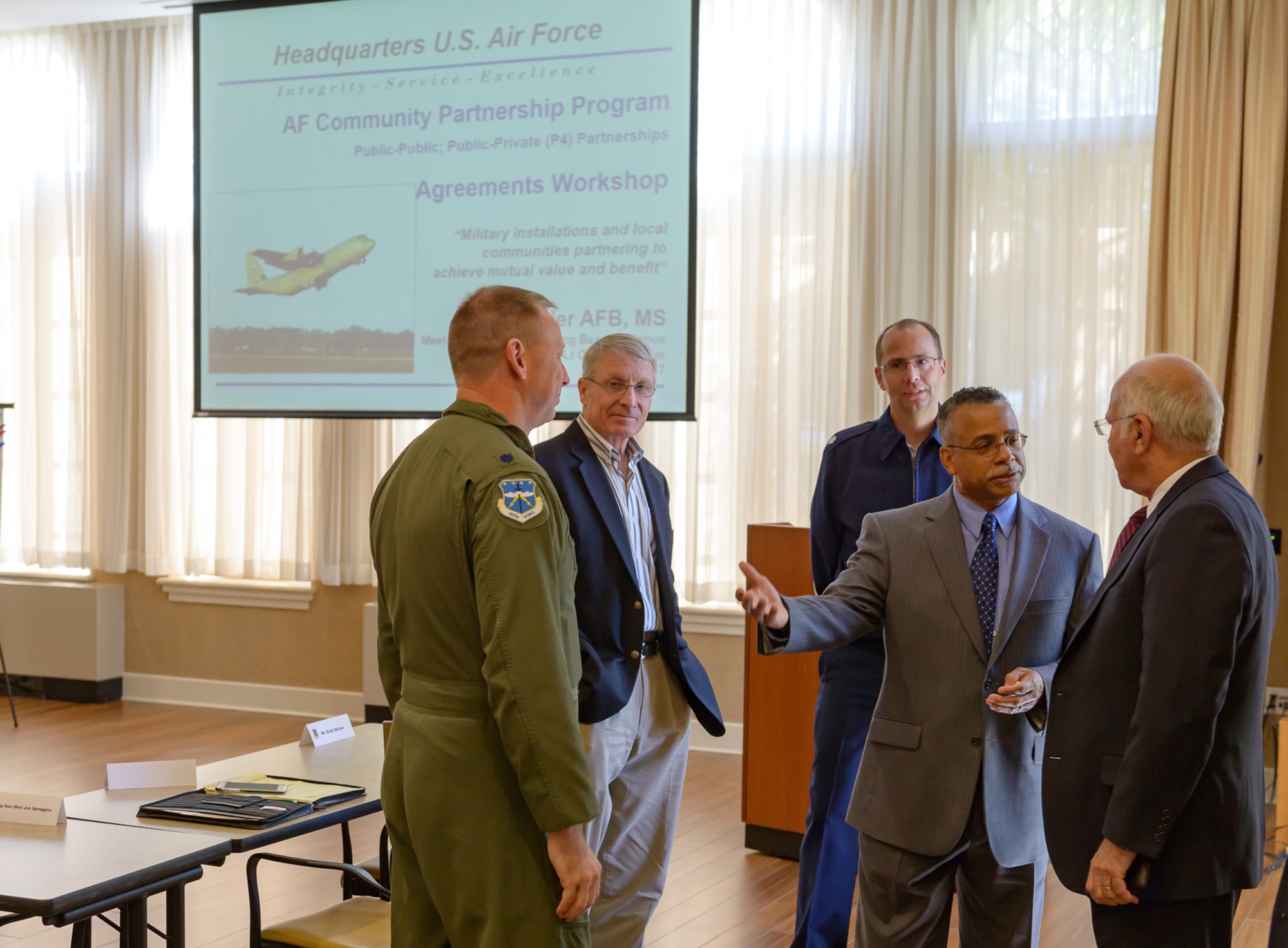 Dr. Wayne Clark, 81st Mission Support Group deputy director, introduces attendees to U.S. Army retired Col. Fred Meurer (right) during the Air Force Community Partnership Program Agreements Workshop at the Gulf Park Campus of The University of Southern Mississippi Oct. 25, 2017, Long Beach, Mississippi. The program is part of a larger Air Force Public-Public, Public-Private (P4) initiative to encourage installations and local communities to combine or improve resources or operating processes. Mississippi representatives from state and local communities and various civic leaders attended the event. (U.S. Air Force photo by Andre’ Askew)