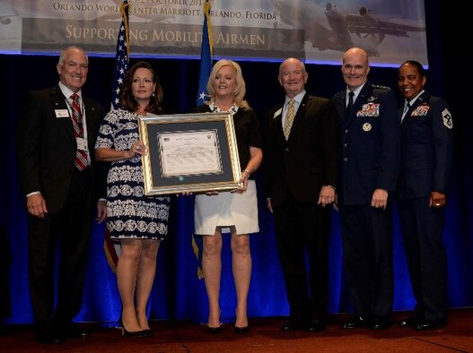 Air Mobility Command Commander Gen. Carlton D. Everhart II presents Dana Lancellotti with the Tampa Bay Trophy at the 2017 Airlift/Tanker Association Symposium Oct. 26, 2017. The symposium brings together Air Force leadership, industry experts and academia, with current and former mobility Airmen. (U.S. Air Force photo by Airman 1st Class Rito Smith)