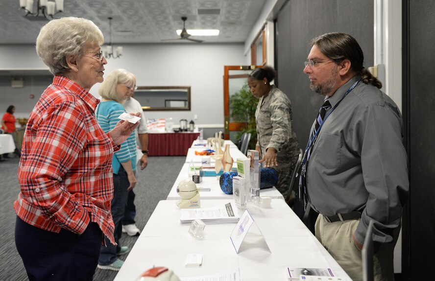 Edie Hyatt speaks with David Ross, 14th Medical Operations Squadron optometry technician, about the benefits retirees are able to utilize Oct. 20, 2017, on Columbus Air Force Base, Mississippi. There are many benefits retirees and beneficiaries may use on military installations, including access to the 14th MDG. (U.S. Air Force photo by Keith Holcomb)