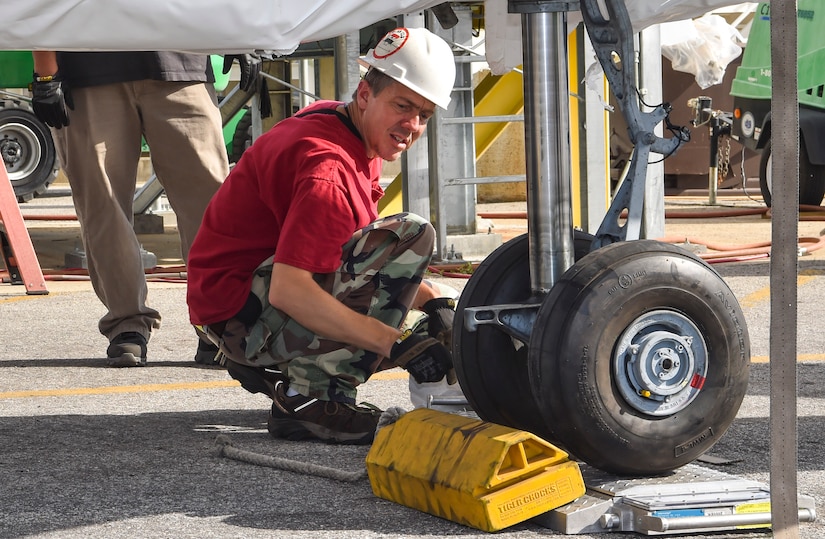 Greg Passmore, 437th Aerial Port Squadron material manager, takes weight measurements for a helicopter training device at Joint Base Charleston, S.C., Oct. 19, 2017.