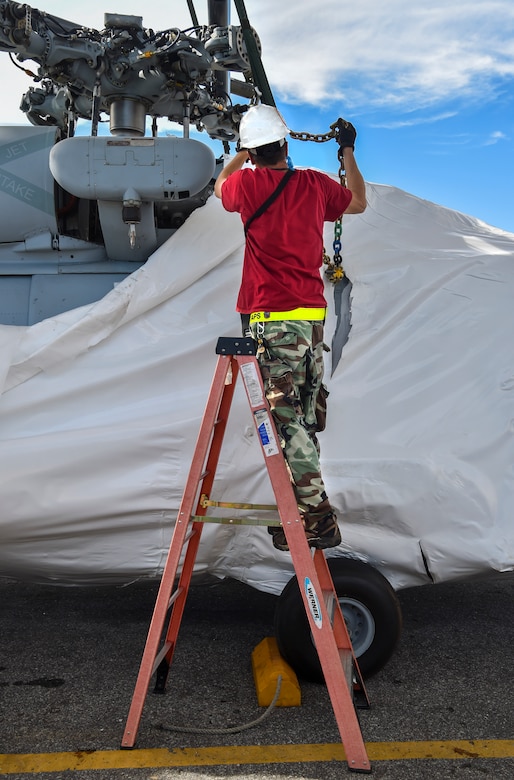 Greg Passmore, 437th Aerial Port Squadron material manager, chains down a helicopter training device for weight measurement at Joint Base Charleston, S.C., Oct. 19, 2017.