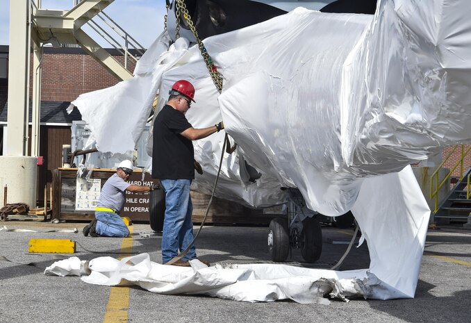 Tom Dybowski, 437th Aerial Port Squadron airfreight operations manager, straps down a helicopter training device for weight measurement at Joint Base Charleston, S.C., Oct. 19, 2017.