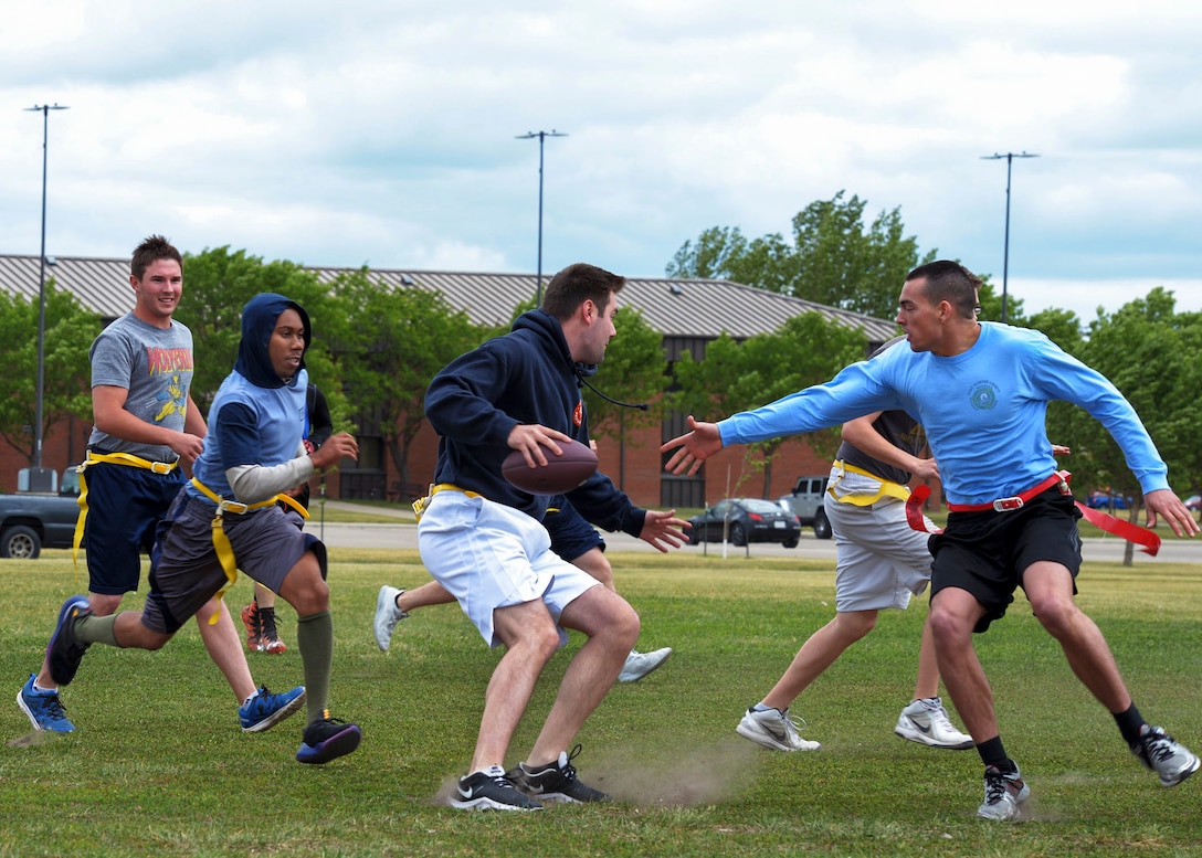 Airmen play a game of flag football during the summer.