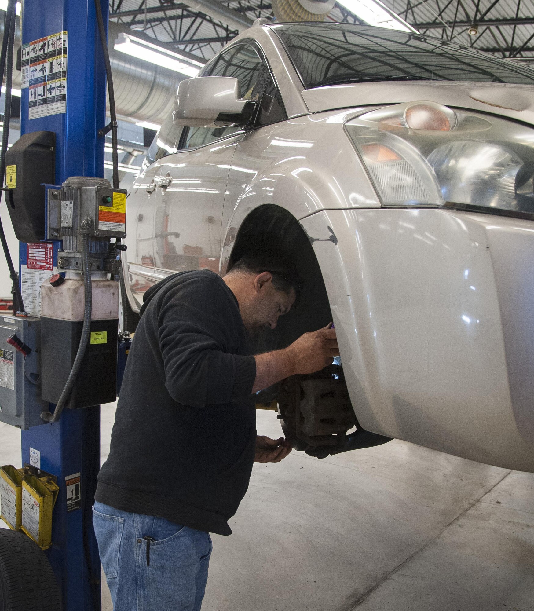 David Horton, auto mechanic, checks the brake pads during a vehicle inspecvtion. Ensuring tires, brakes, and other systems meet factory specifications is important to ensure safe driving throughout the winter.