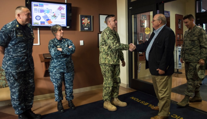 Goose Creek Mayor Michael Heitzler shakes hands with Capt. Dale Barrette, Naval Health Clinic Charleston commanding officer, during an orientation tour of the clinic here, Oct. 25, 2017.