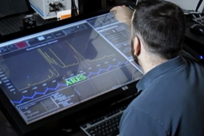 A man looks at a computer screen.