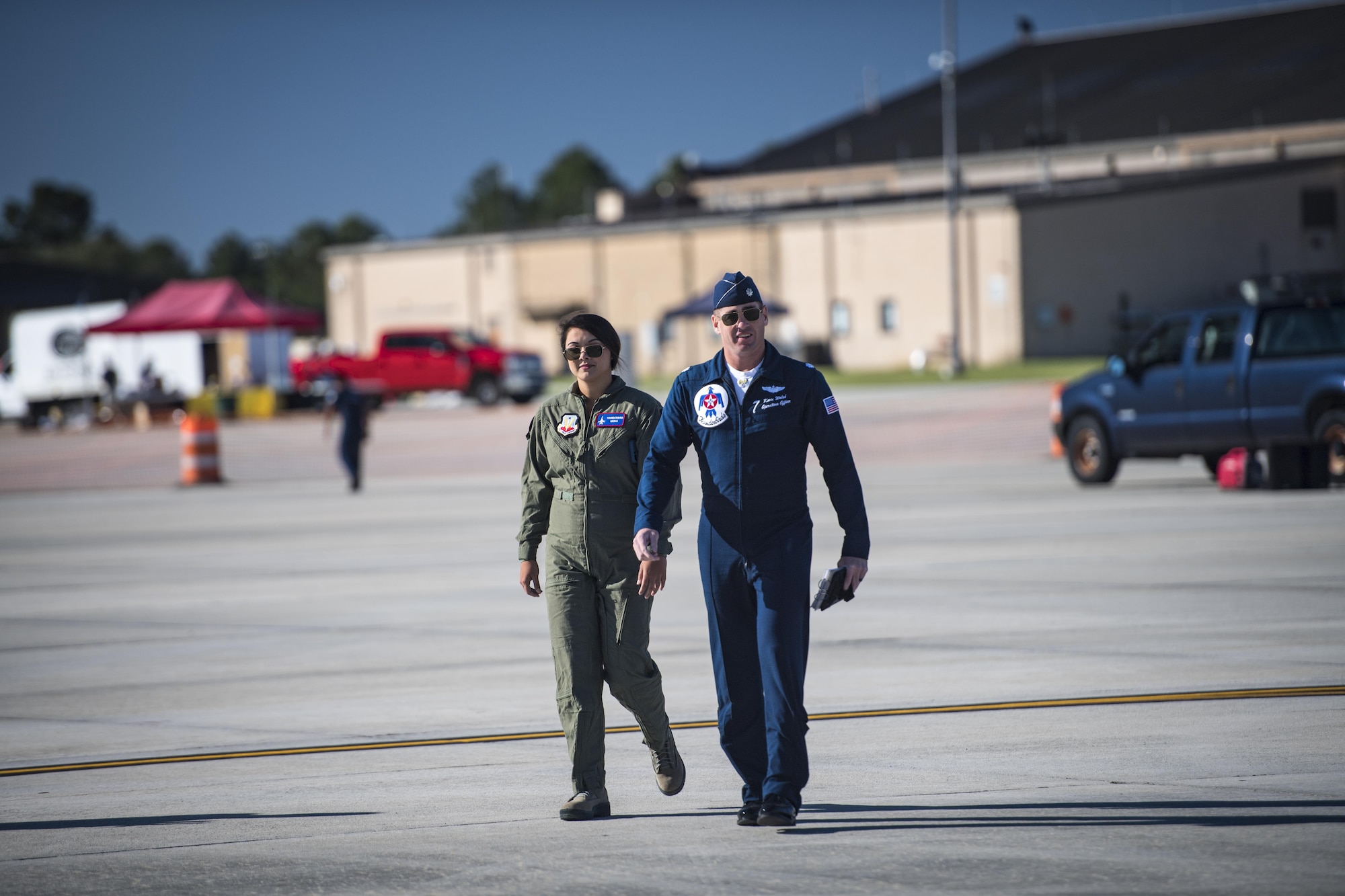 Noelani Mathews, multimedia journalist, walks with Lt. Col. Kevin Walsh, U.S. Air Force Thunderbird pilot No. 7, before her media flight in an F-16D Fighting Falcon, Oct. 27, 2017, at Moody Air Force Base, Ga. The Thunderbirds, based out of Nellis Air Force Base, Nev., are the Air Force’s premier aerial demonstration team, performing at air shows and special events worldwide. (U.S. Air Force photo by Senior Airman Janiqua P. Robinson)