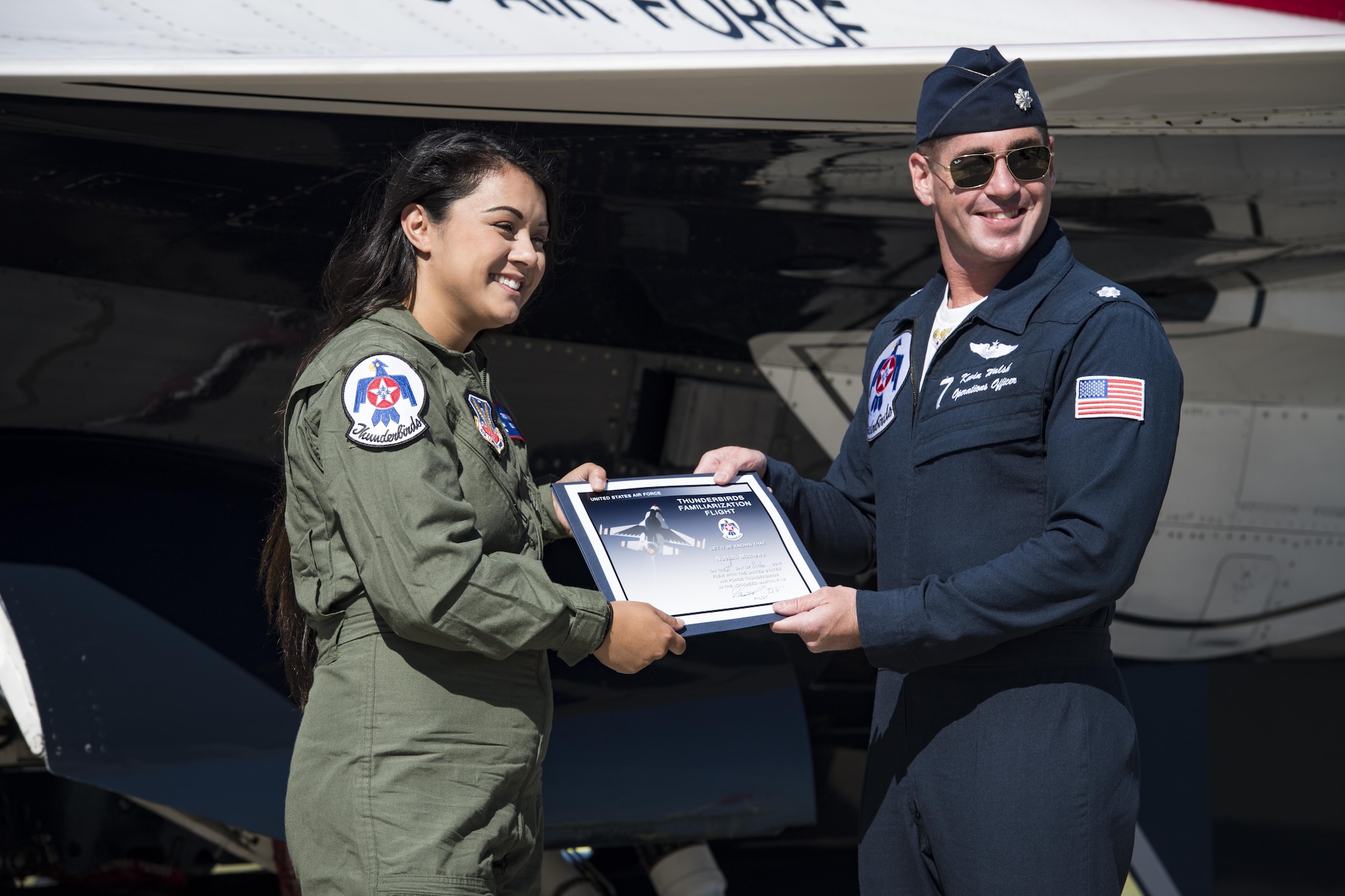 Noelani Mathews, multimedia journalist, and Lt. Col. Kevin Walsh, U.S. Air Force Thunderbird pilot No. 7, pose with her flight certificate after her media flight in an F-16D Fighting Falcon, Oct. 27, 2017, at Moody Air Force Base, Ga. The Thunderbirds, based out of Nellis Air Force Base, Nev., are the Air Force’s premier aerial demonstration team, performing at air shows and special events worldwide. (U.S. Air Force photo by Senior Airman Janiqua P. Robinson)