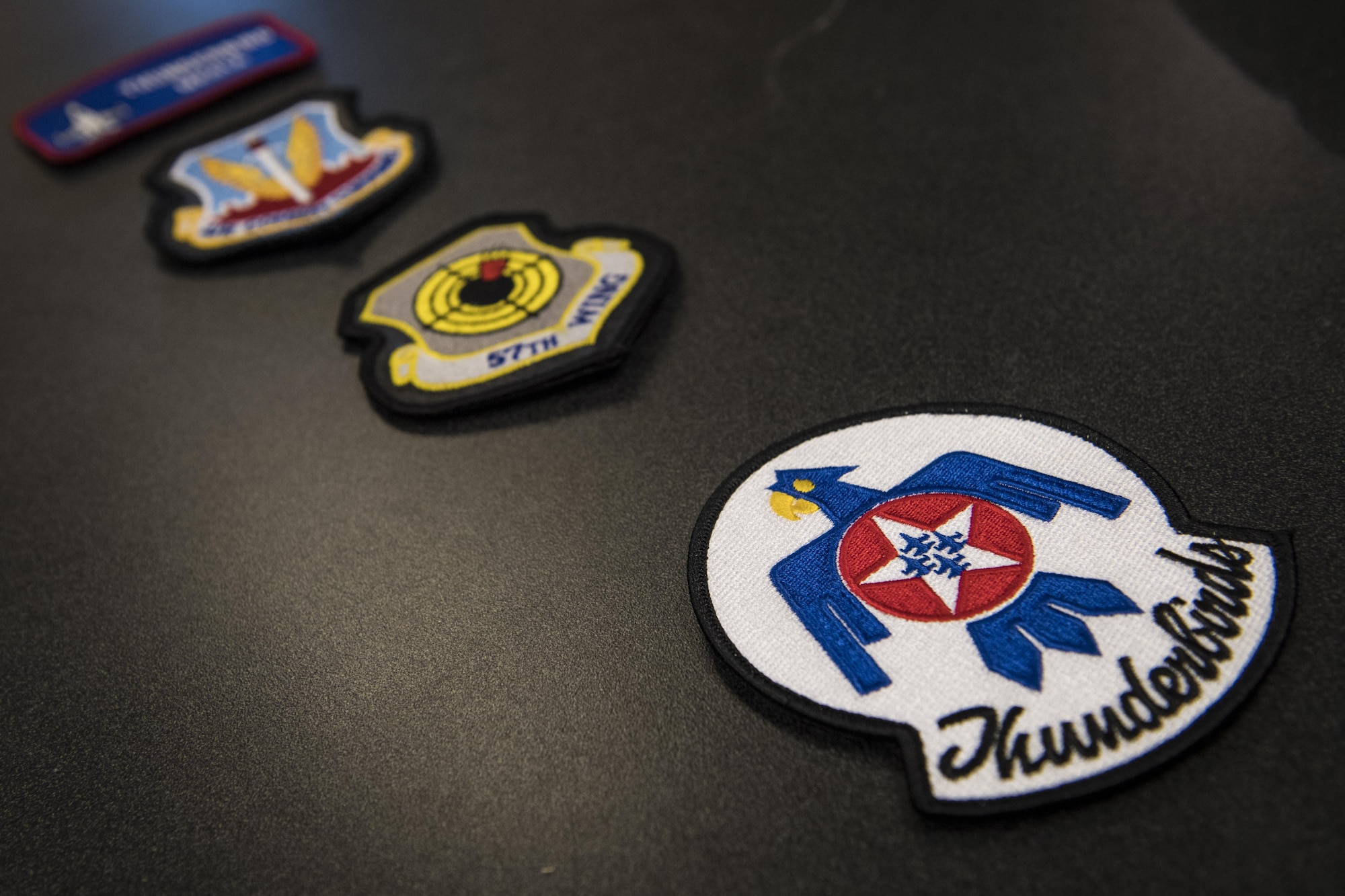 Patches rest on a table before being presented to Noelani Mathews, multimedia journalist, before her media flight in an F-16D Fighting Falcon, Oct. 27, 2017, at Moody Air Force Base, Ga. The U.S. Air Force Thunderbirds, based out of Nellis Air Force Base, Nev., are the Air Force’s premier aerial demonstration team, performing at air shows and special events worldwide. (U.S. Air Force photo by Senior Airman Janiqua P. Robinson)