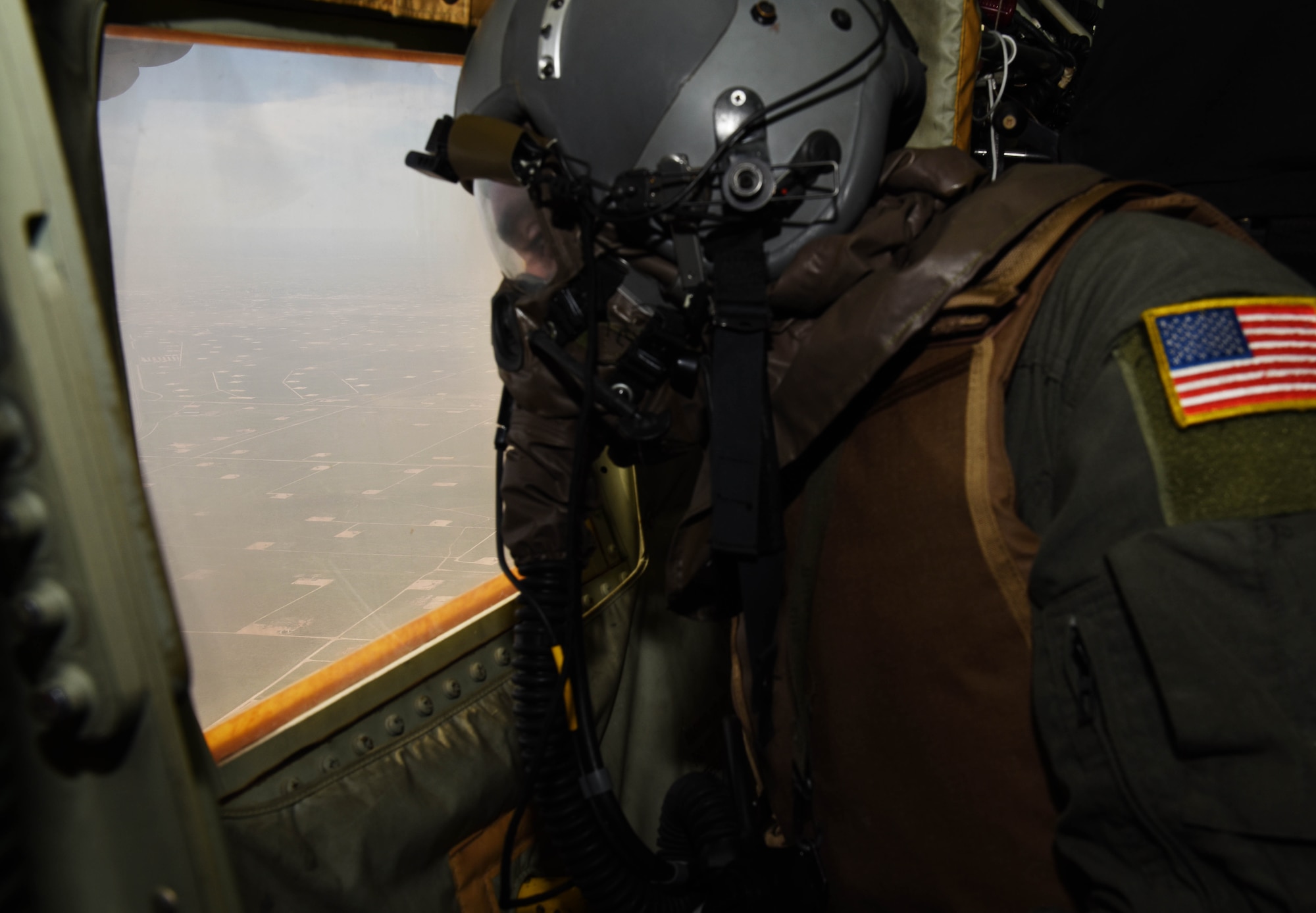 Senior Airman James Camera, 40th Airlift Squadron, loadmaster, scans for threats during a full spectrum readiness sortie