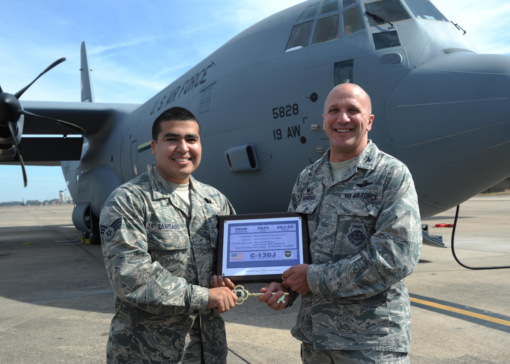 Senior Airman Julian Santiago, 19th Maintenance Squadron dedicated crew chief, receives the key to Little Rock's newest C-130J from Yakota AB, Japan