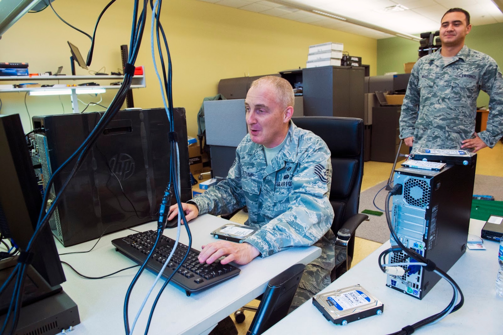 Staff Sgt. Sean Stump, 434 Communications Squadron network operations technician, and Herman Vasquez, 434 CS network infrastructure technician, install a new operating system to a series of hard drives at Grissom Air Reserve Base, Oct. 25, 2017. Over 1400 Grissom computers required upgrades from Windows 7 to Windows 10 before the end of 2017. (U.S. Air Force photo/ Senior Airman Harrison Withrow)