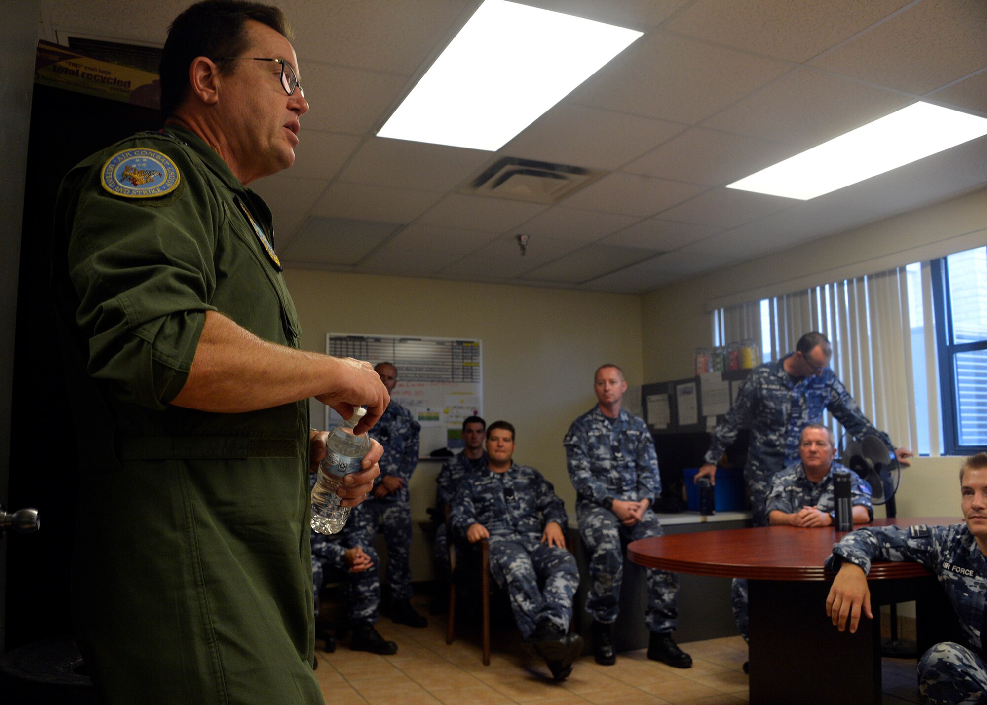 Air Commodore Mike Kitcher, Commander Air Combat Group of the Royal Australian Air Force, speaks with members of the Australian F-35A Transition Team embedded with the 61st Fighter Squadron and Aircraft Maintenance Unit during a visit to Luke Air Force Base, Ariz., Oct. 25, 2017. AIRCDRE Kitcher spoke with Australian pilots and maintenance personnel about his vision for the transition of the F-35A into Australian service, and he thanked the 56th Fighter Wing and Lockheed Martin for supporting the Australian mission. (U.S. Air Force photo by Senior Airman Devante Williams)