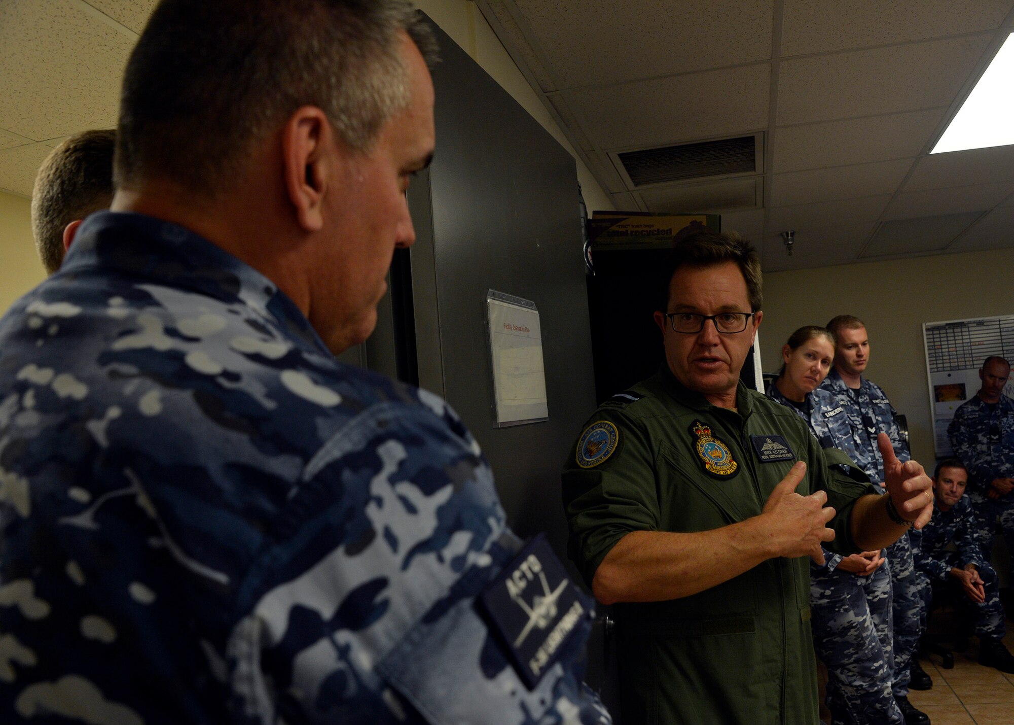Air Commodore Mike Kitcher, Commander Air Combat Group of the Royal Australian Air Force, speaks with members of the Australian F-35A Transition Team embedded with the 61st Fighter Squadron and Aircraft Maintenance Unit during a visit to Luke Air Force Base, Ariz., Oct. 25, 2017. AIRCDRE Kitcher spoke with Australian pilots and maintenance personnel about his vision for the transition of the F-35A into Australian service, and he thanked the 56th Fighter Wing and Lockheed Martin for supporting the Australian mission. (U.S. Air Force photo by Senior Airman Devante Williams)