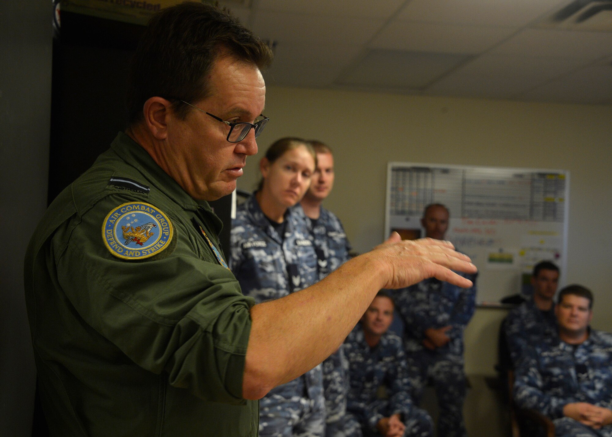 Air Commodore Mike Kitcher, Commander Air Combat Group of the Royal Australian Air Force, speaks with members of the Australian F-35A Transition Team embedded with the 61st Fighter Squadron and Aircraft Maintenance Unit during a visit to Luke Air Force Base, Ariz., Oct. 25, 2017. AIRCDRE Kitcher spoke with Australian pilots and maintenance personnel about his vision for the transition of the F-35A into Australian service, and he thanked the 56th Fighter Wing and Lockheed Martin for supporting the Australian mission. (U.S. Air Force photo by Senior Airman Devante Williams)