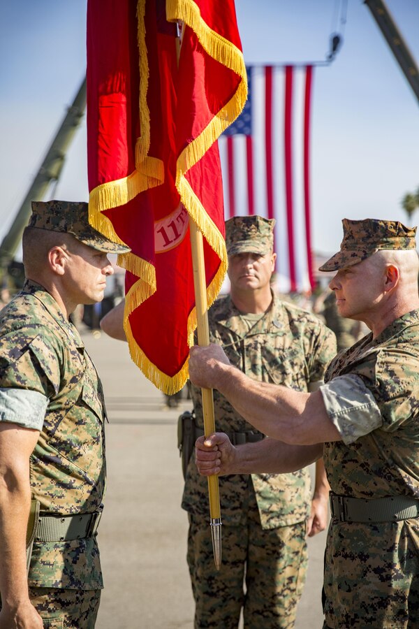 MARINE CORPS BASE CAMP PENDLETON, California - Colonel Clay C. Tipton, right, offgoing commanding officer of the 11th Marine Expeditionary Unit, passes the 11th MEU unit colors to Col. Fridrik Fridriksson, oncoming commanding officer of 11th MEU during a change of command ceremony aboard Marine Corps Base Camp Pendleton, California, Oct. 27. The passing of the colors is a Marine Corps tradition signifying the passing of the responsibility of command. (U.S. Marine Corps photo by Lance Cpl. Jacob A. Farbo)