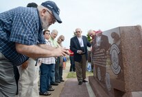 Retired Chief Master Sgt. Stephen Spotts takes a photo of the new C-141 Starlifter memorial in the Maj. Charles B. Hall Memorial Airpark.