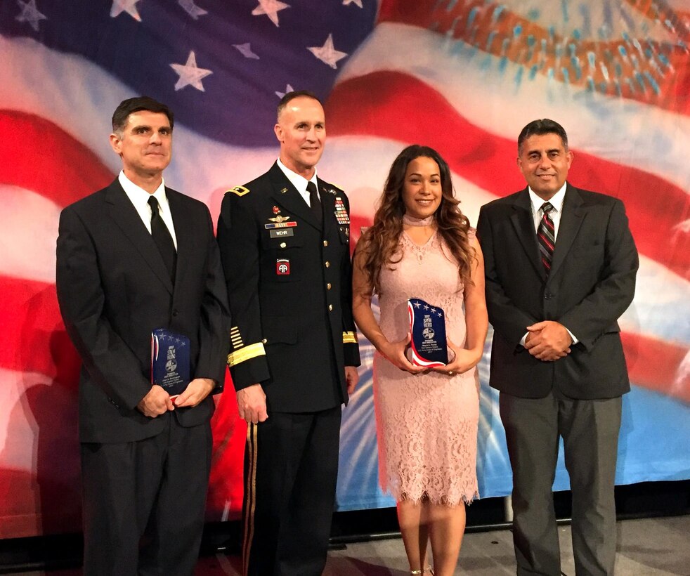 Maj. Gen. Michael Wehr, deputy commanding general for the U.S. Army Corps of Engineers, presents Great Minds in STEM awards to (from left) Juan Dominguez, Mayra Flores and Carlos Gonzalez at the 29th annual Hispanic Engineer National Achievement Awards Corporation conference Oct. 18 to 22 in Pasadena, California.