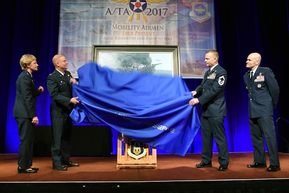 (From Left to right) Lt. Gen. Maryanne Miller, chief of the Air Force Reserve and commander of Air Force Reserve Command, Col. James Devere, 302nd Airlift Wing commander, Senior Master Sgt. Darby Perrin, artist, and Gen. Carlton D. Everhart II, commander of Air Mobility Command unveiled the painting "Earth, Blood and Fire" at the 49th annual Air Mobility Command and Airlift/Tanker Association Symposium in Orlando, Florida. The painting depicts the Modular Airborne Fire Fighting Systems mission of the 731st Airlift Squadron, 302 AW, Peterson Air Force Base, Colorado. (U.S. Air Force photo by Tech. Sgt. Peter Dean)