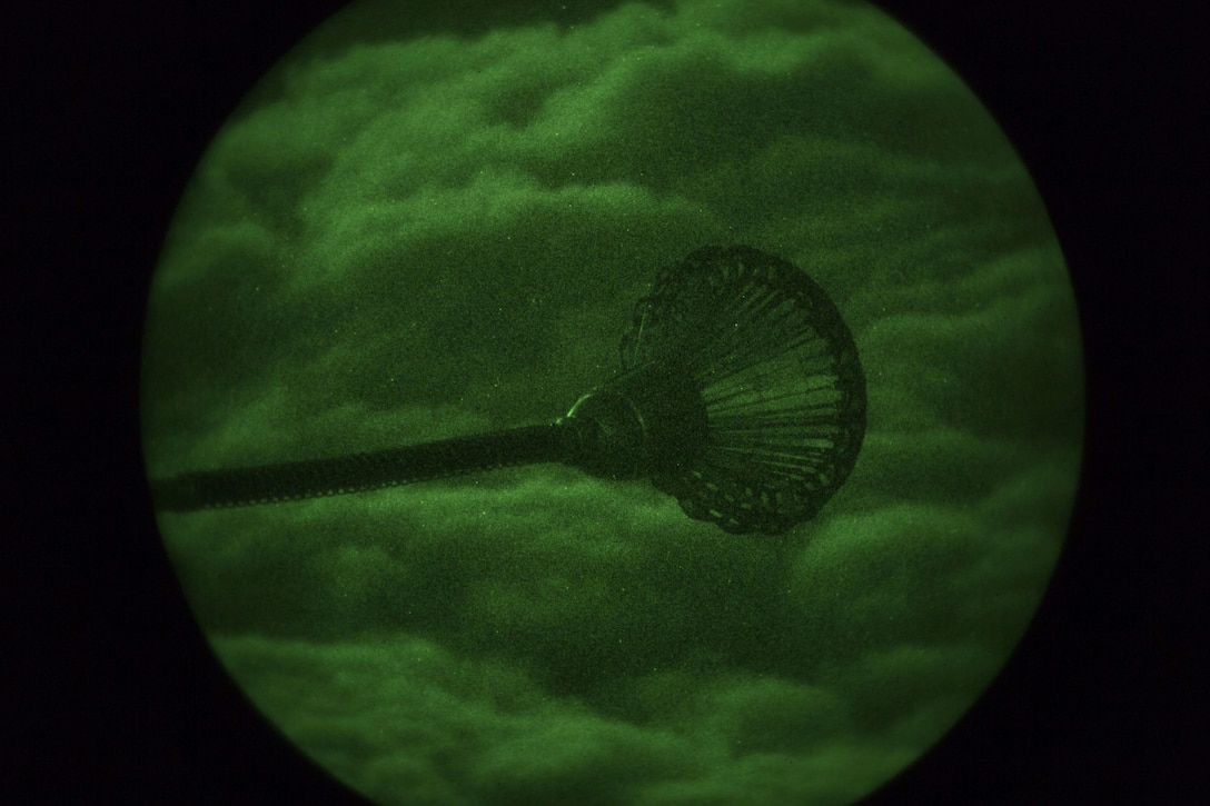 A drogue from a KC-130J Hercules with Marine Aerial Refueler Transport Squadron (VMGR) 152 based out of Marine Corps Air Station (MCAS) Iwakuni, Japan, prepares to refuel an F-35B Lightning II aircraft with Marine Fighter Attack Squadron (VMFA) 121 based out of MCAS Iwakuni during a nighttime aerial refueling training operation Oct. 25, 2017. The training was conducted at night to improve operational readiness and pilot proficiency. (U.S. Marine Corps photo by Lance Cpl. Stephen Campbell)