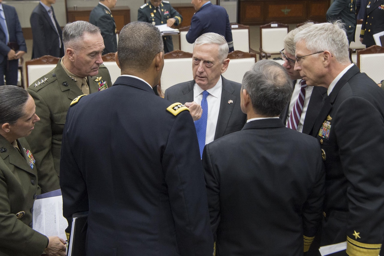 Defense leaders converse during security meetings in Seoul, South Korea.