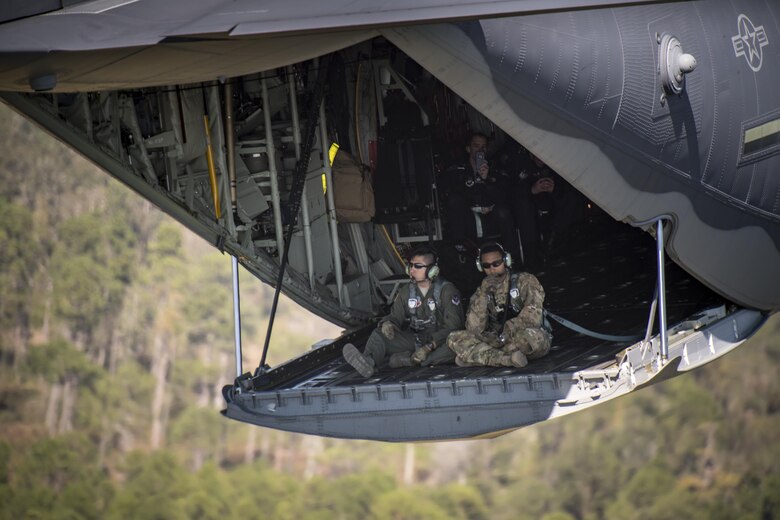 Staff Sgt. Edgar Elizalde, left, and Tech. Sgt. Curtis Copeland, 71st Rescue Squadron loadmasters, sit on the ramp in an HC-130J Combat King II during the Thunder Over South Georgia Air Show, Oct. 28, 2017, at Moody Air Force Base, Ga. The open house is an opportunity for Moody to thank the local community for all its support, and exhibit air power and it included aerial performances, food, face painting and much more. (U.S. Air Force photo by Staff Sgt. Ryan Callaghan)