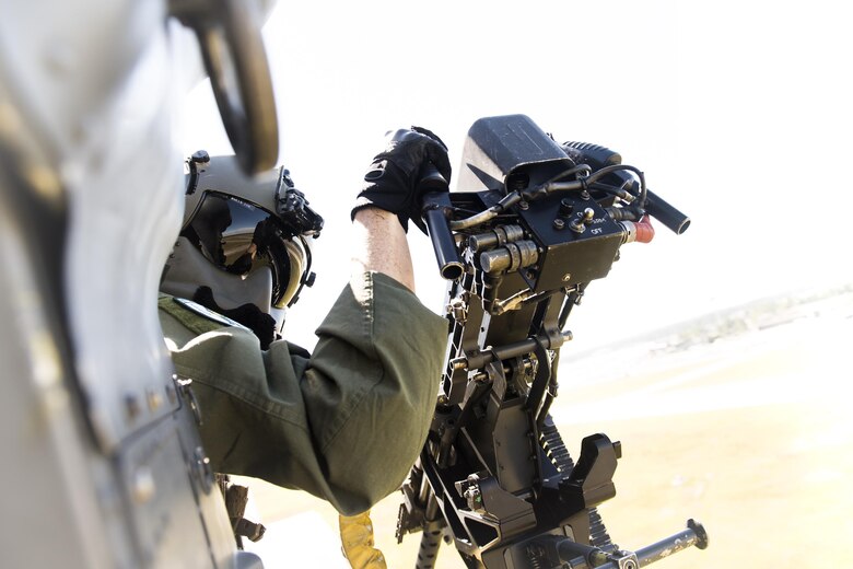 Staff Sgt. Bernard McSally, 41st Rescue Squadron special missions aviator, looks out the side of an HH-60G Pave Hawk during the Thunder Over South Georgia Air Show, Oct. 28, 2017, at Moody Air Force Base, Ga. The open house is an opportunity for Moody to thank the local community for all its support, and exhibit air power and it included aerial performances, food, face painting and much more. (U.S. Air Force photo by Staff Sgt. Ryan Callaghan)