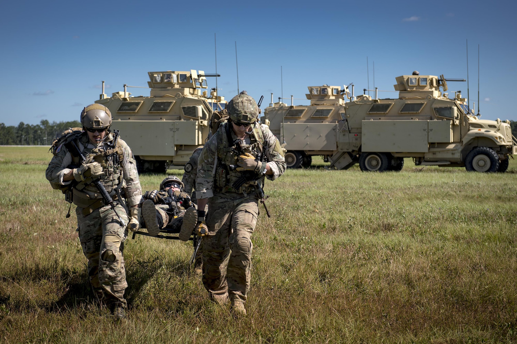 Airmen from the 38th Rescue Squadron and the 820th Base Defense Group carry a simulated patient to an HH-60G Pave Hawk during the Thunder Over South Georgia Air Show, Oct. 28, 2017, at Moody Air Force Base, Ga. The open house is an opportunity for Moody to thank the local community for all its support, and exhibit air power and it included aerial performances, food, face painting and much more. (U.S. Air Force photo by Staff Sgt. Ryan Callaghan) (U.S. Air Force photo by Staff Sgt. Ryan Callaghan)