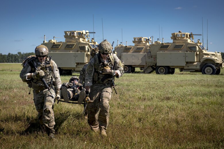 Airmen from the 38th Rescue Squadron and the 820th Base Defense Group carry a simulated patient to an HH-60G Pave Hawk during the Thunder Over South Georgia Air Show, Oct. 28, 2017, at Moody Air Force Base, Ga. The open house is an opportunity for Moody to thank the local community for all its support, and exhibit air power and it included aerial performances, food, face painting and much more. (U.S. Air Force photo by Staff Sgt. Ryan Callaghan) (U.S. Air Force photo by Staff Sgt. Ryan Callaghan)