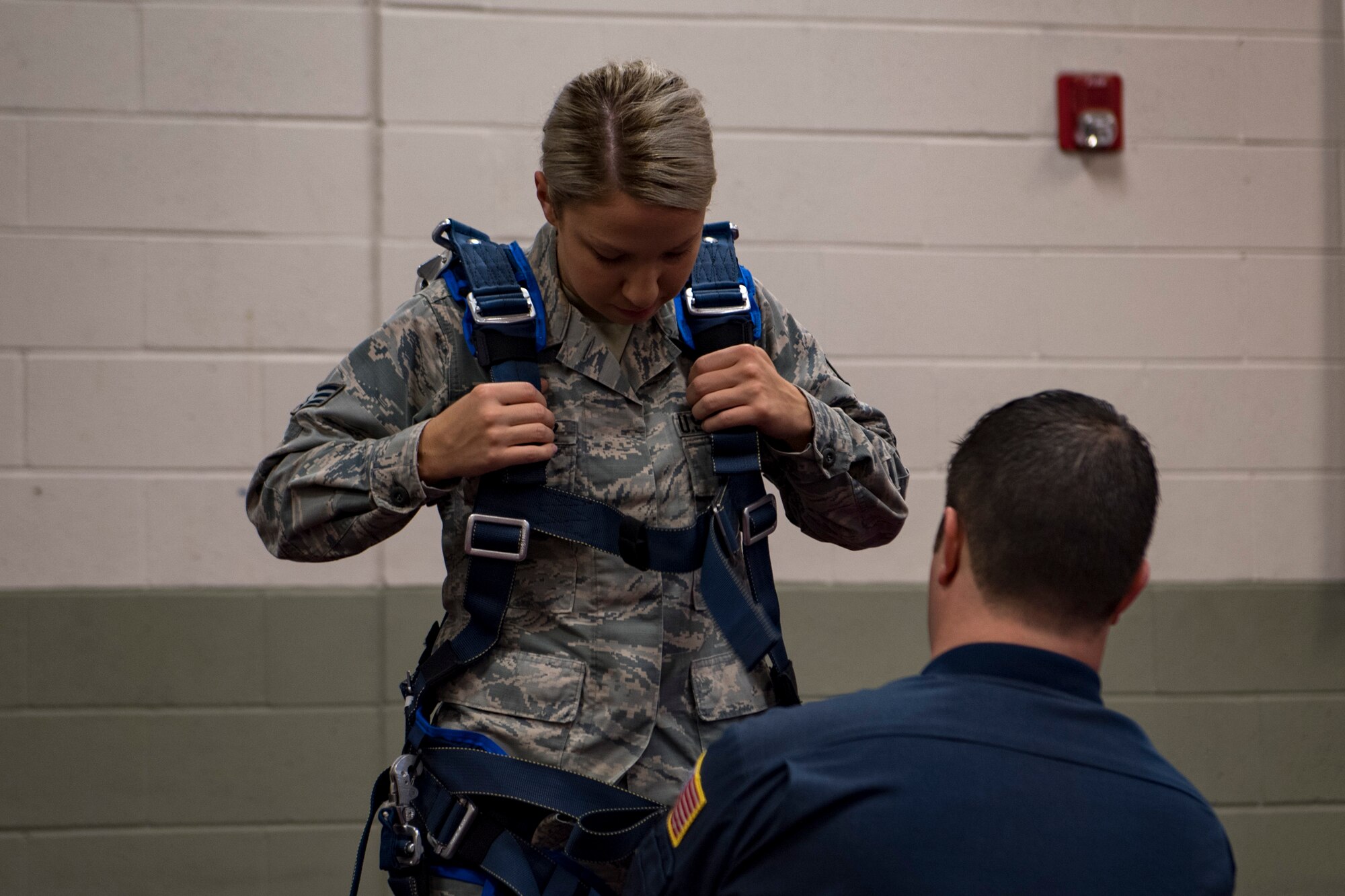 Senior Airman Jordan Rodriguez, 23d Medical Support Squadron medical lab technician, dons equipment used in a tandem free-fall jump during the Thunder Over South Georgia Air Show, Oct. 28, 2017, at Moody Air Force Base, Ga. This jump was led held by the Wings of Blue parachute team from the U.S. Air Force Academy. (U.S. Air Force photo by Senior Airman Daniel Snider)