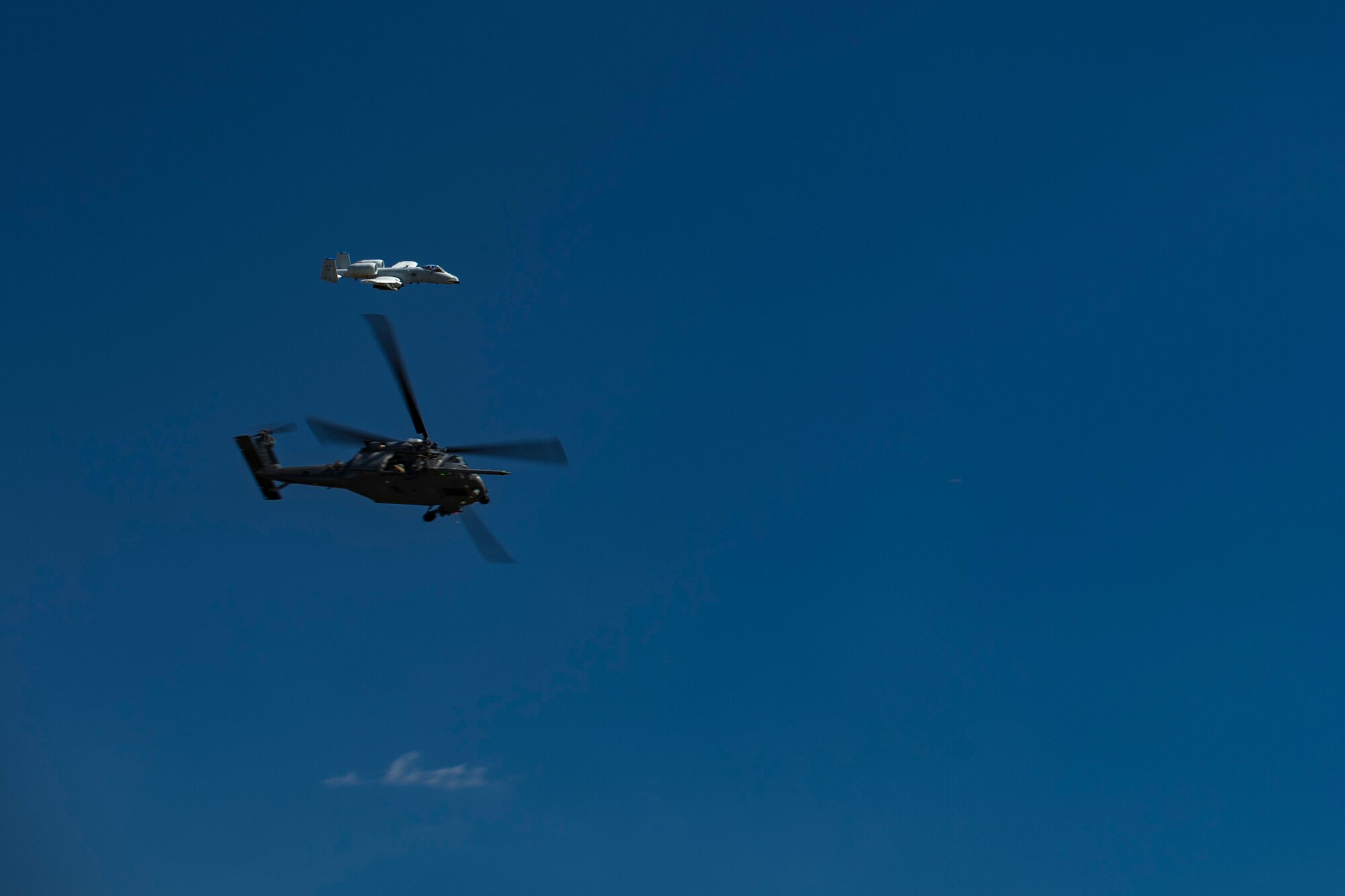 An HH-60G Pave Hawk and an A-10C Thunderbolt II fly over Moody Air Force Base, Ga., during the Thunder Over South Georgia Air Show, Oct. 28, 2017. The air show aims to educate the public on past and present Air Force capabilities, increase recruiting and show appreciation to the local community. (U.S. Air Force photo by Senior Airman Daniel Snider)