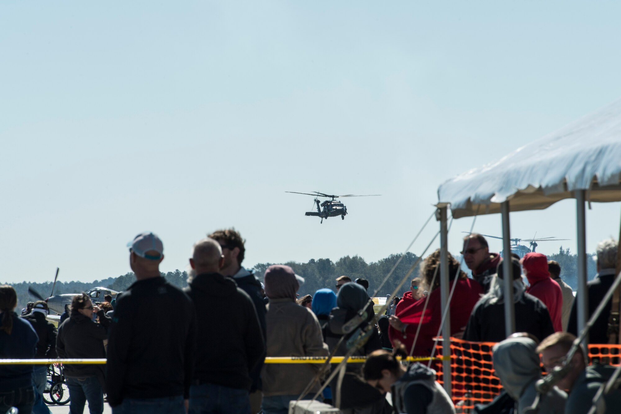 Spectators watch as an HH60G Pave Hawk flies during the Thunder Over South Georgia Air Show, Oct. 29, 2017, at Moody Air Force Base, Ga. The open house is an opportunity for Moody to thank the local community for all its support, and exhibit air power. (U.S. Air Force photo by Senior Airman Janiqua P. Robinson)