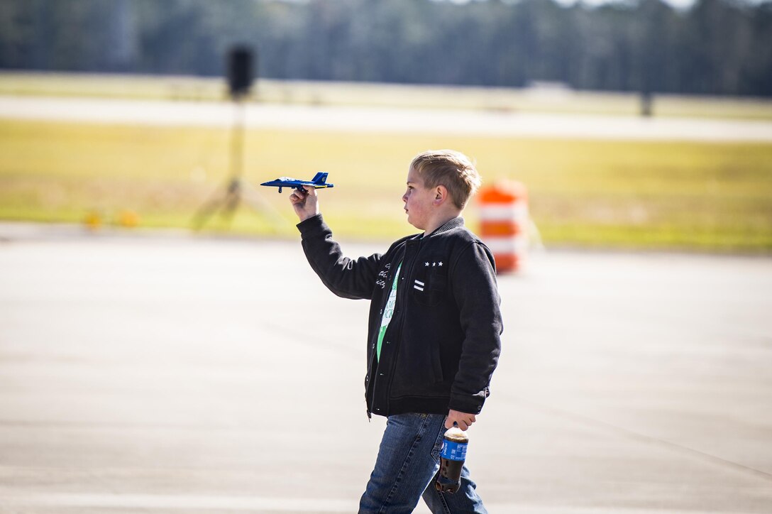 A spectator plays with a U.S. Navy Blue Angels aircraft during the Thunder Over South Georgia Air Show, Oct. 29, 2017, at Moody Air Force Base, Ga. Throughout the show, guests viewed aircraft through the ages perform such as the P-51 Mustang, a World War II fighter, and the Moody’s own A-10C Thunderbolt IIs. (U.S. Air Force Staff Sgt. Ceaira Young)
