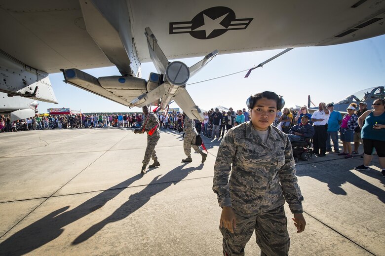 Airmen from the 23d Maintenance Group perform a weapons load demonstration in front of a crowd of spectators, during Thunder Over South Georgia, Oct. 28, 2017, at Moody Air Force Base, Ga. In addition to aerial events, the air show also provided a unique opportunity to educate the public on past and present Air Force capabilities, increase recruiting and show appreciation to the local community. (U.S. Air Force Staff Sgt. Ceaira Young)