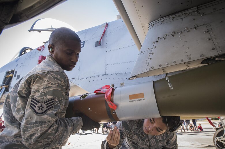 Airmen from the 23d Maintenance Group perform a weapons load demonstration in front of a crowd of spectators, during Thunder Over South Georgia, Oct. 28, 2017, at Moody Air Force Base, Ga.In addition to aerial events, the air show also provided a unique opportunity to educate the public on past and present Air Force capabilities, increase recruiting and show appreciation to the local community. (U.S. Air Force Staff Sgt. Ceaira Young)