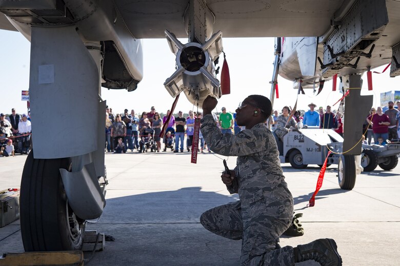 Airmen from the 23d Maintenance Group perform a weapons load demonstration in front of a crowd of spectators, during Thunder Over South Georgia, Oct. 28, 2017, at Moody Air Force Base, Ga.In addition to aerial events, the airshow also provided a unique opportunity to educate the public on past and present Air Force capabilities, increase recruiting and show appreciation to the local community. (U.S. Air Force photo by Andrea Jenkins)