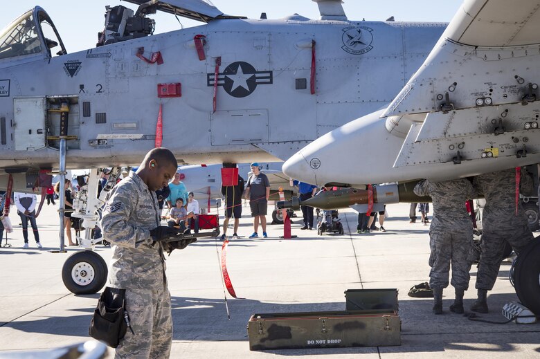 Airmen from the 23d Maintenance Group perform a weapons load demonstration in front of a crowd of spectators, during Thunder Over South Georgia, Oct. 28, 2017, at Moody Air Force Base, Ga. In addition to aerial events, the air show also provided a unique opportunity to educate the public on past and present Air Force capabilities, increase recruiting and show appreciation to the local community. (U.S. Air Force photo by Andrea Jenkins)