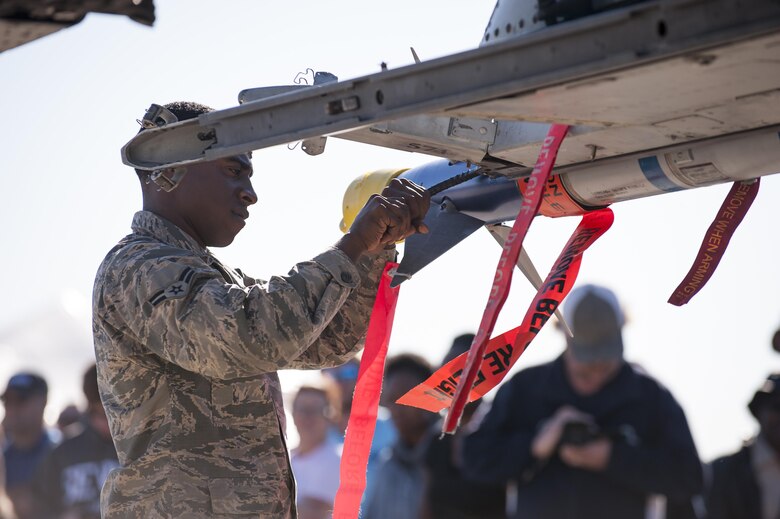 Airmen from the 23d Maintenance Group perform a weapons load demonstration in front of a crowd of spectators, during Thunder Over South Georgia, Oct. 28, 2017, at Moody Air Force Base, Ga.In addition to aerial events, the airshow also provided a unique opportunity to educate the public on past and present Air Force capabilities, increase recruiting and show appreciation to the local community. (U.S. Air Force photo by Andrea Jenkins)